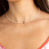 woman wearing a beaded keshi pearl necklace in sand color