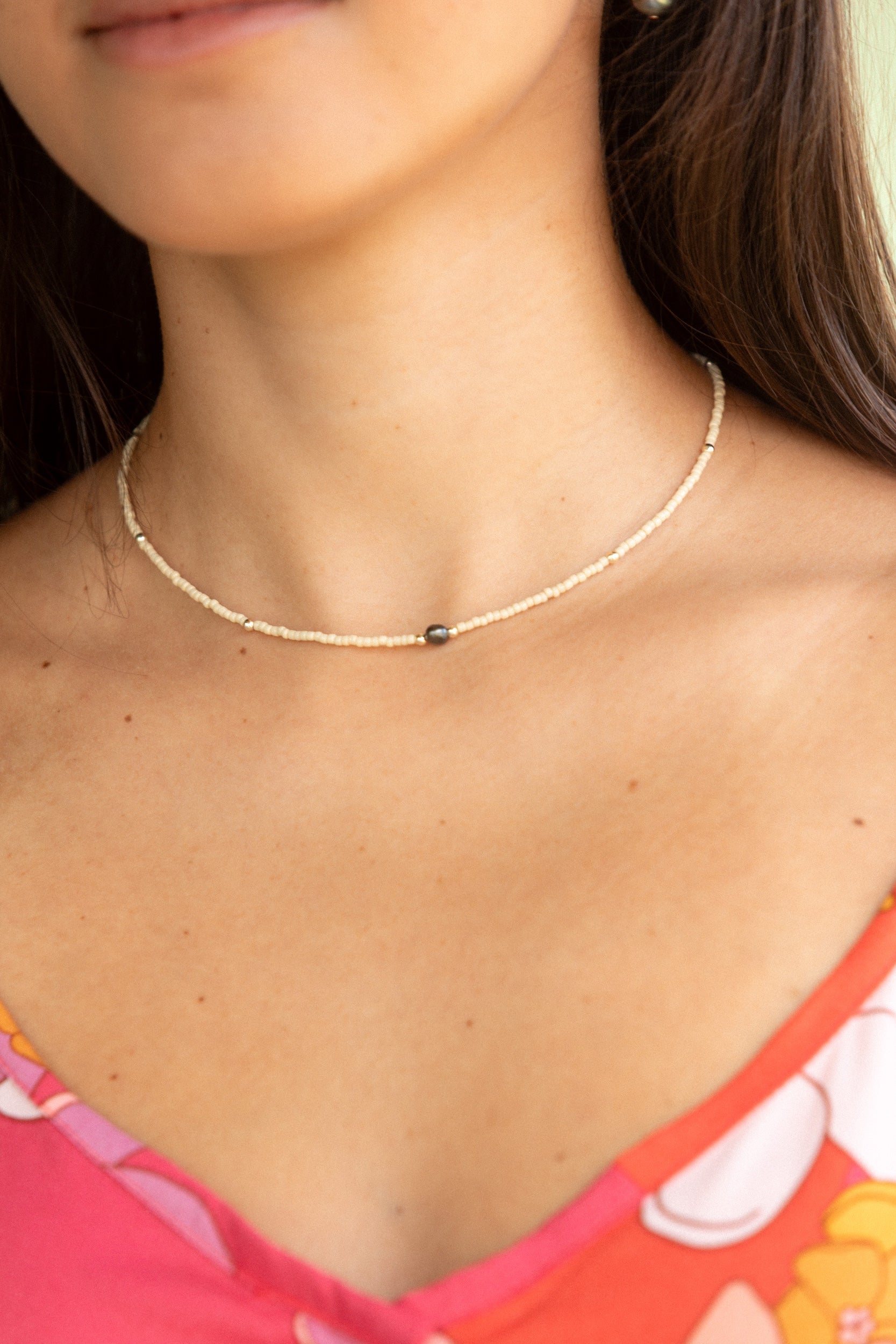 woman wearing a beaded keshi pearl necklace in sand color