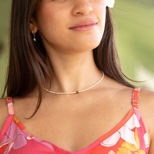 woman wearing a beaded keshi pearl necklace in sand color