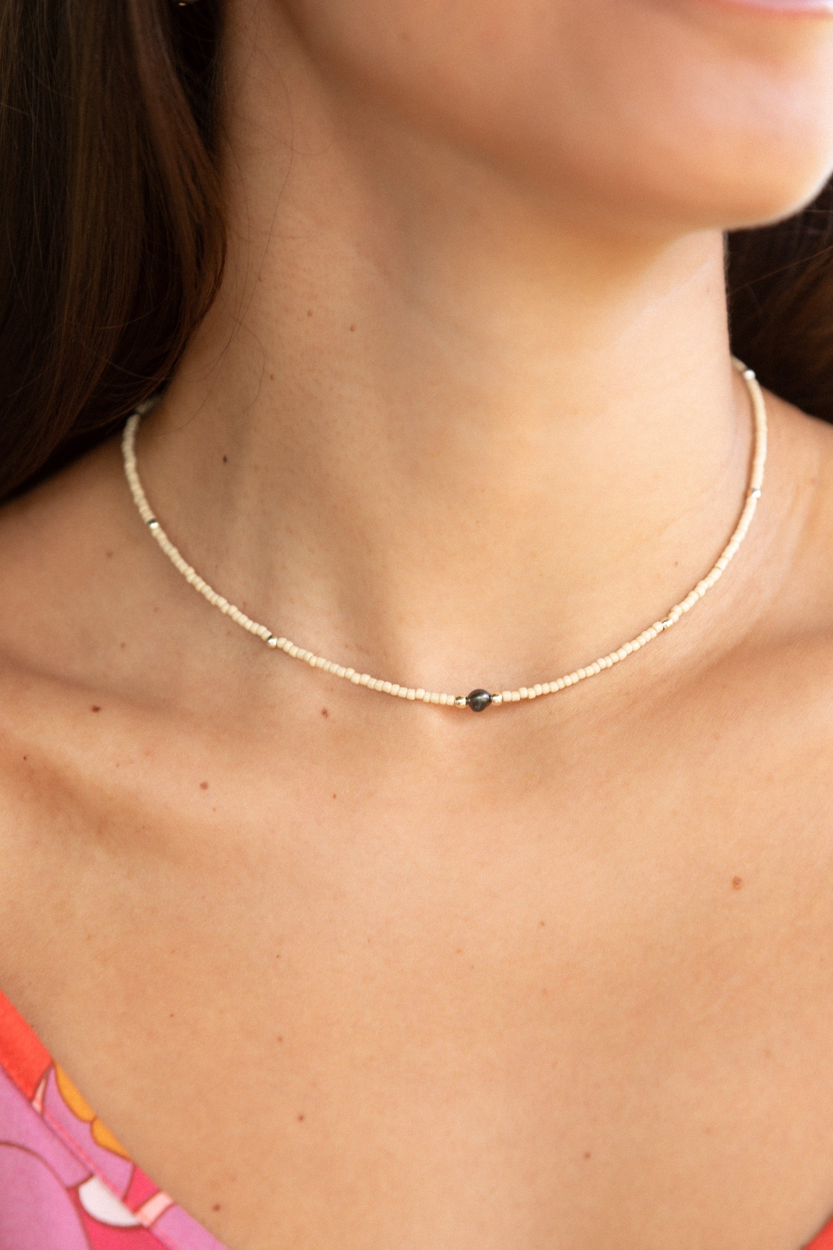 woman wearing a beaded keshi pearl necklace in sand color