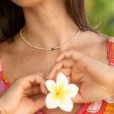 woman wearing a beaded keshi pearl necklace in sand color