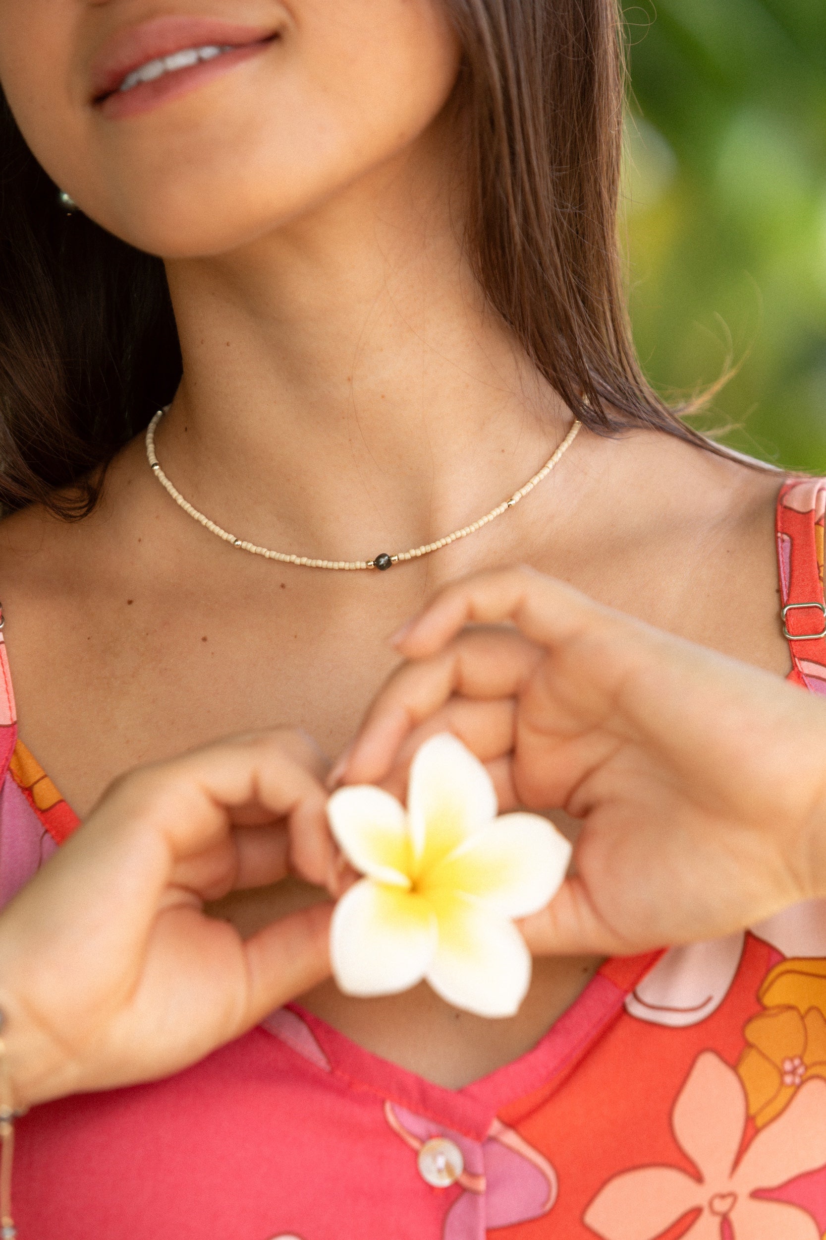 woman wearing a beaded keshi pearl necklace in sand color