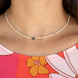 woman wearing a beaded keshi pearl necklace in sand color