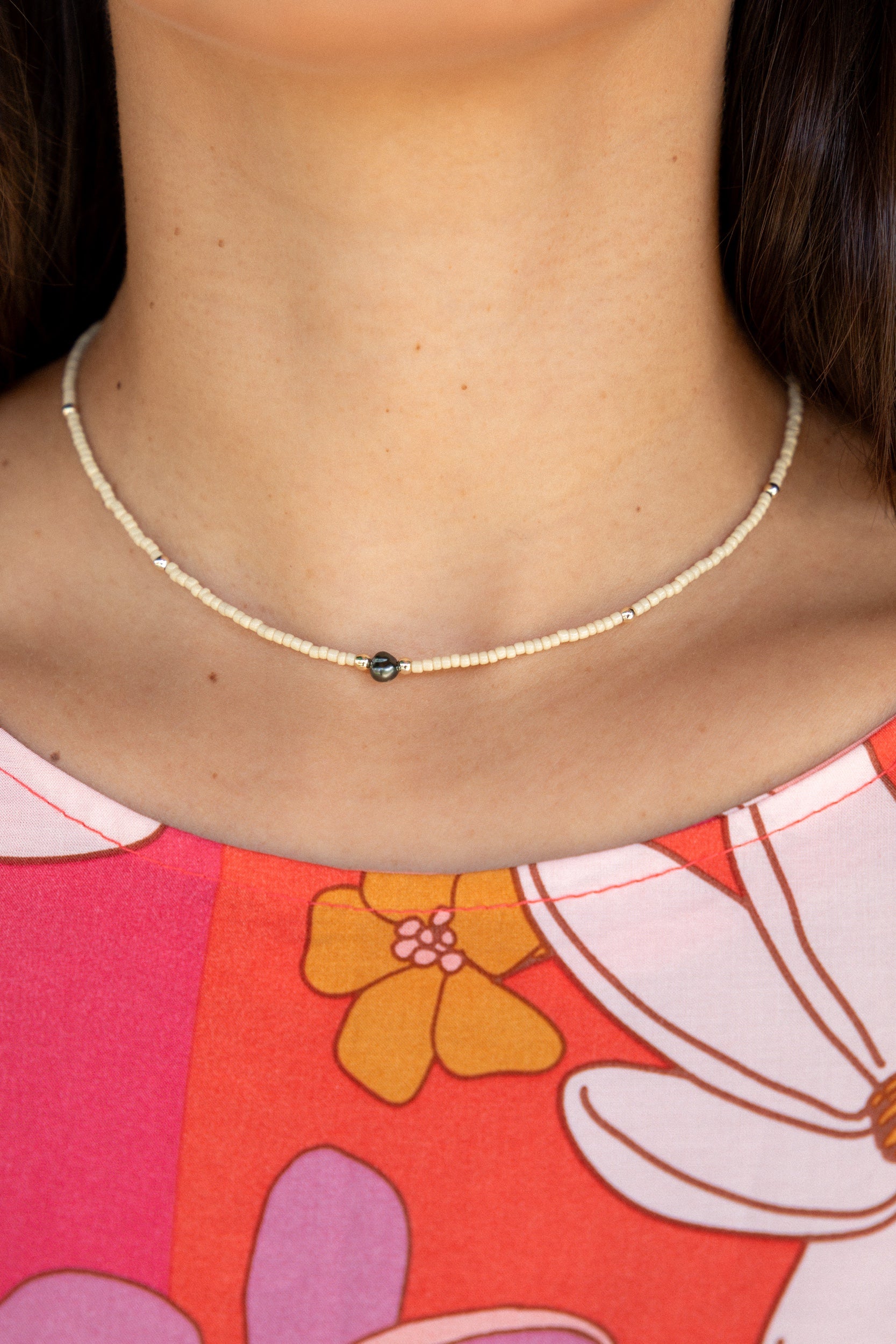woman wearing a beaded keshi pearl necklace in sand color