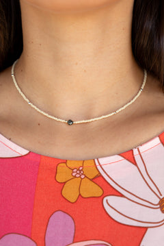 woman wearing a beaded keshi pearl necklace in sand color