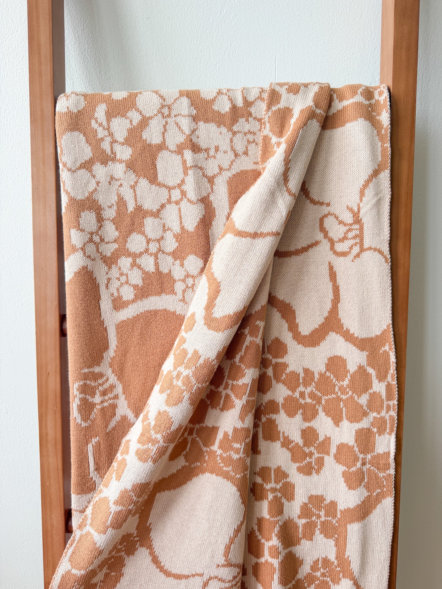 tan/nude woven cotton blanket featuring puakenikeni print