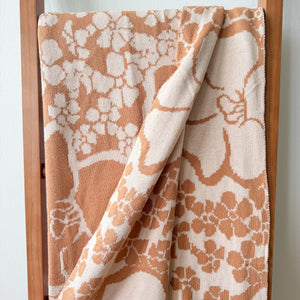 tan/nude woven cotton blanket featuring puakenikeni print