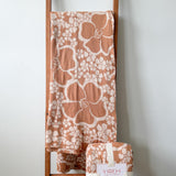 tan/nude woven cotton blanket featuring puakenikeni print