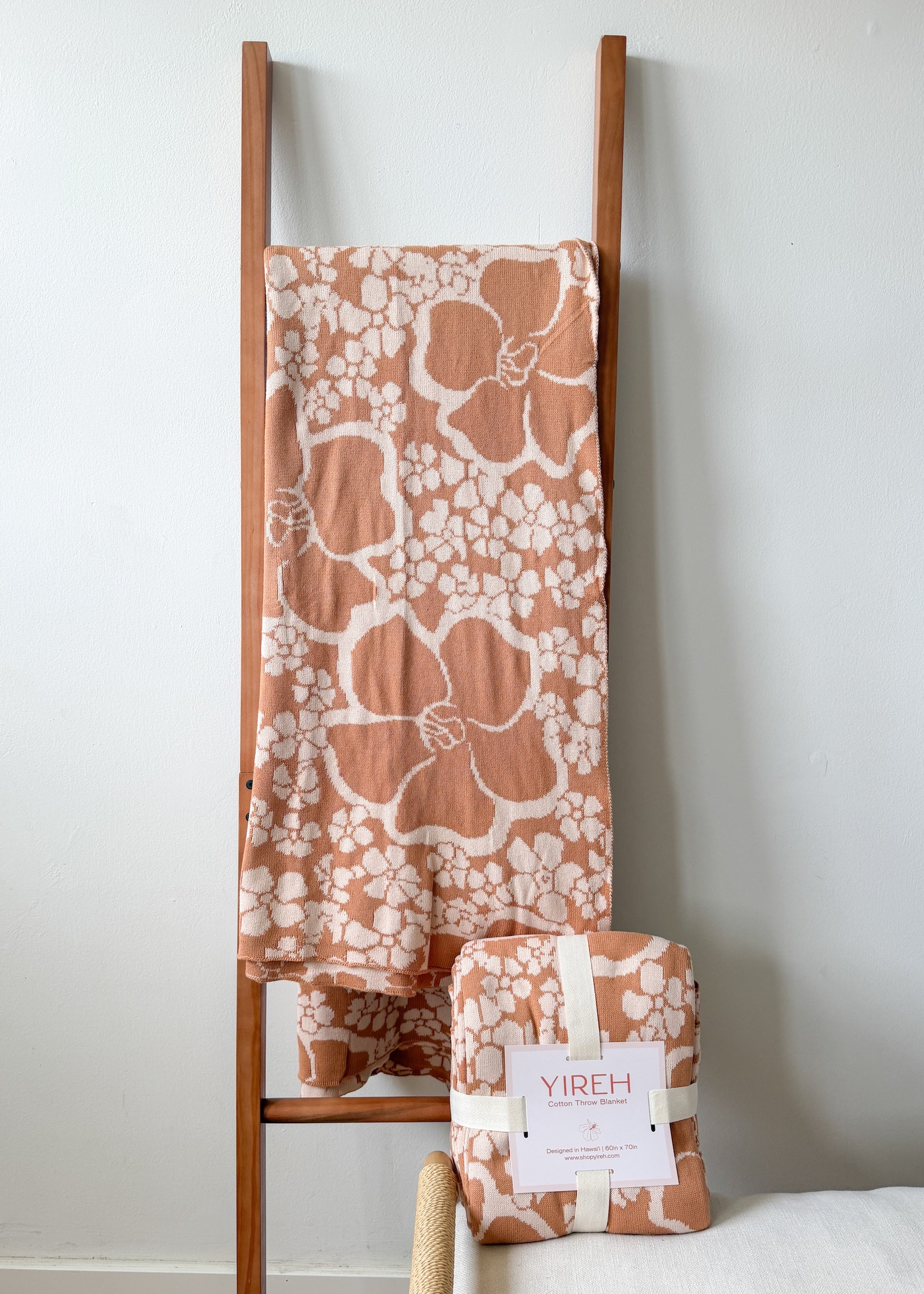 tan/nude woven cotton blanket featuring puakenikeni print