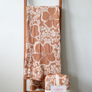 tan/nude woven cotton blanket featuring puakenikeni print