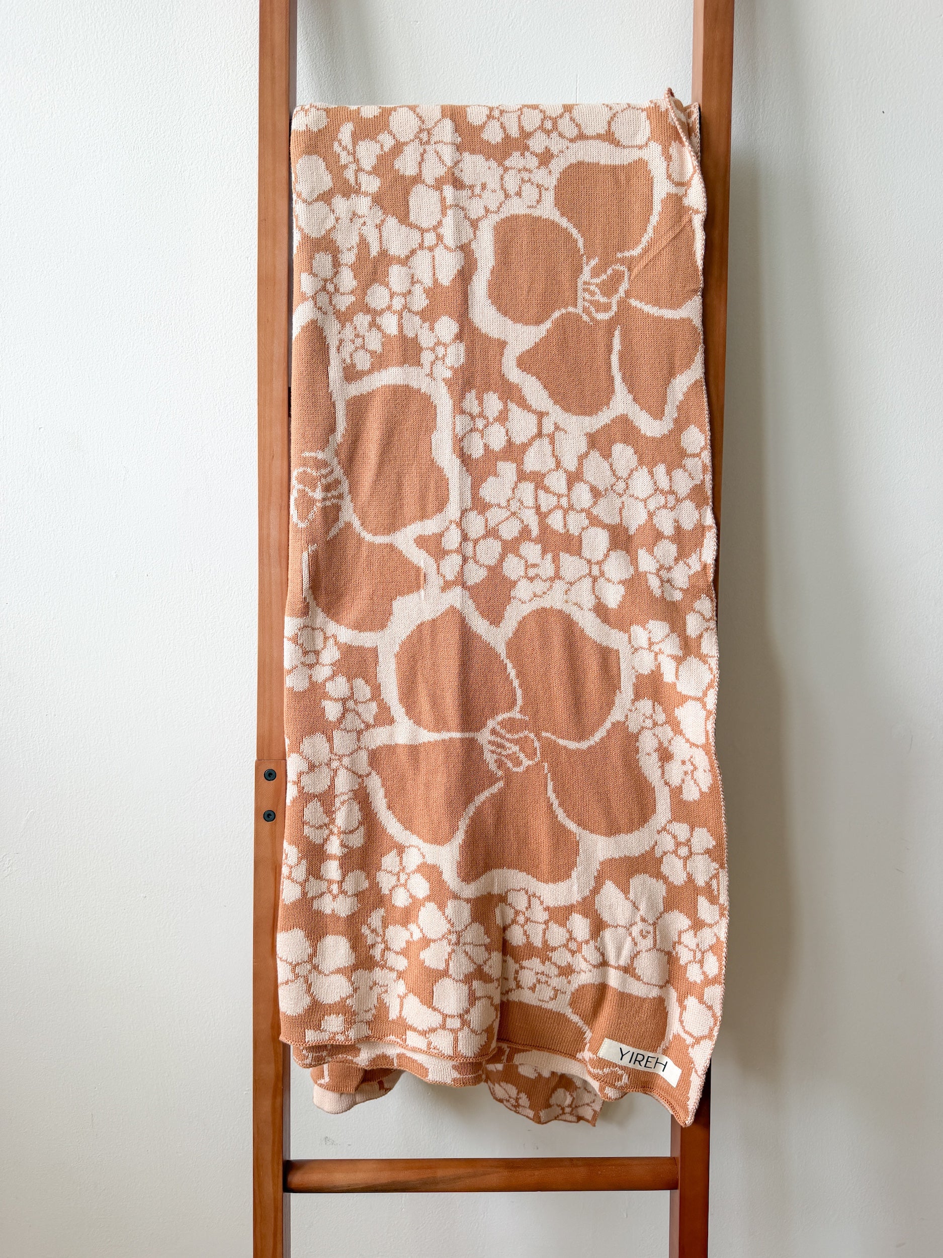 tan/nude woven cotton blanket featuring puakenikeni print