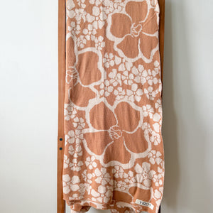 tan/nude woven cotton blanket featuring puakenikeni print