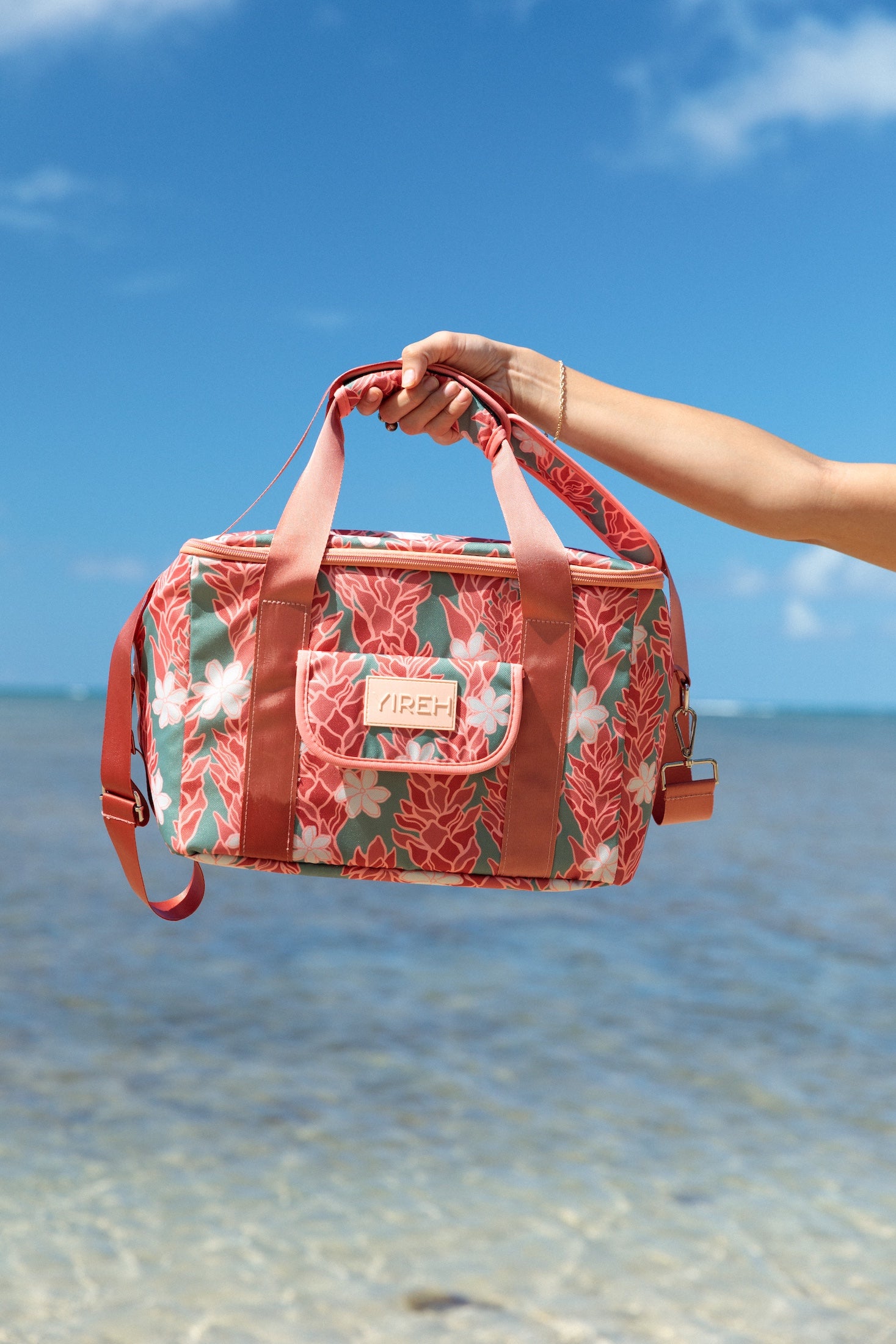 green cooler bag with tiare and red ginger floral pattern