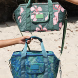 large cooler bag in blue green color with lei pattern featuring straps and handle