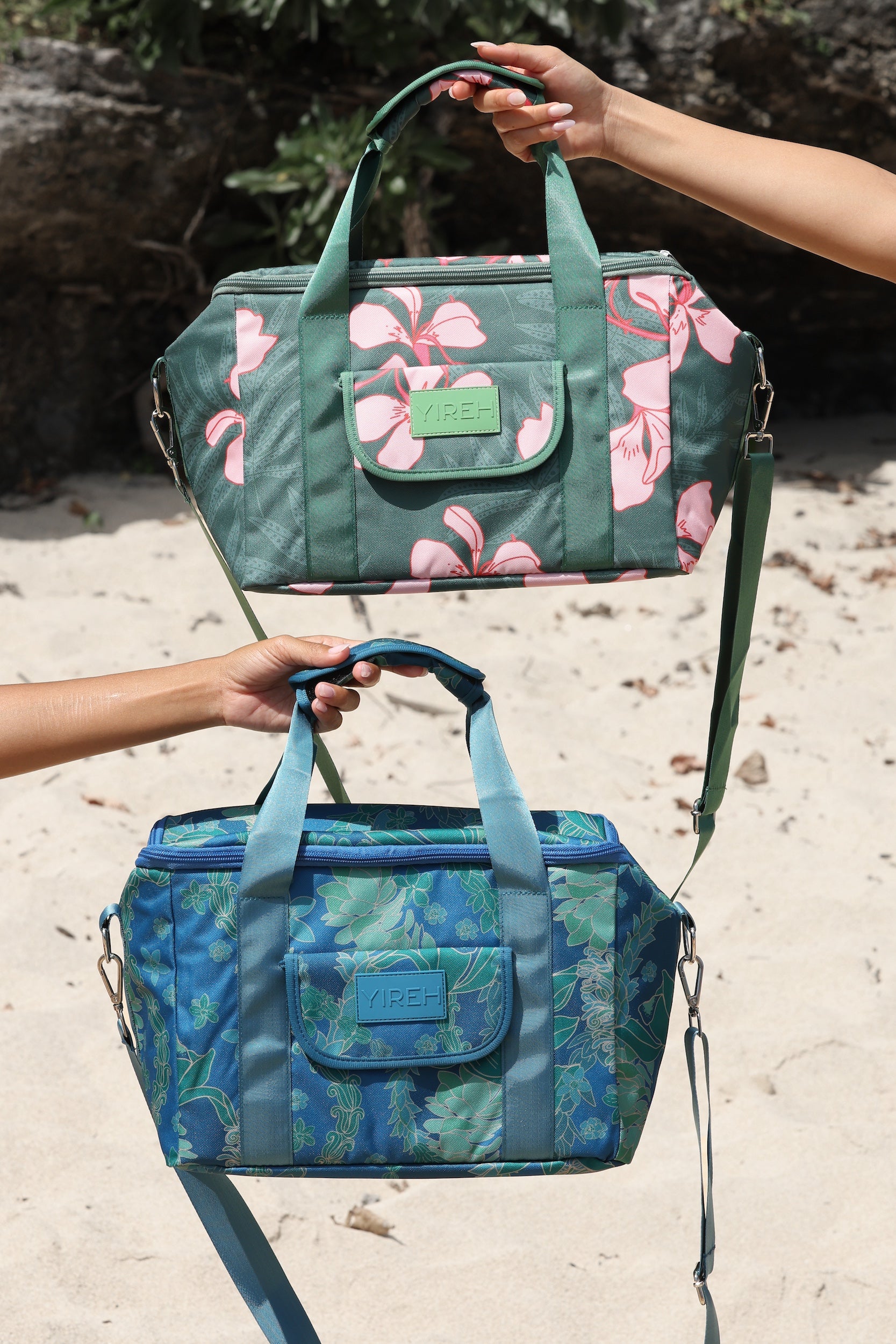 large cooler bag in blue green color with lei pattern featuring straps and handle