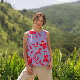 woman with brown hair wearing a sleeveless blouse with periwinkle background and bright red hibiscus print.