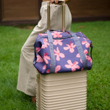 navy blue large travel tote with luggage sleeve, adjustable strap, duster bag, detachable mini pouches, and zipper compartments.