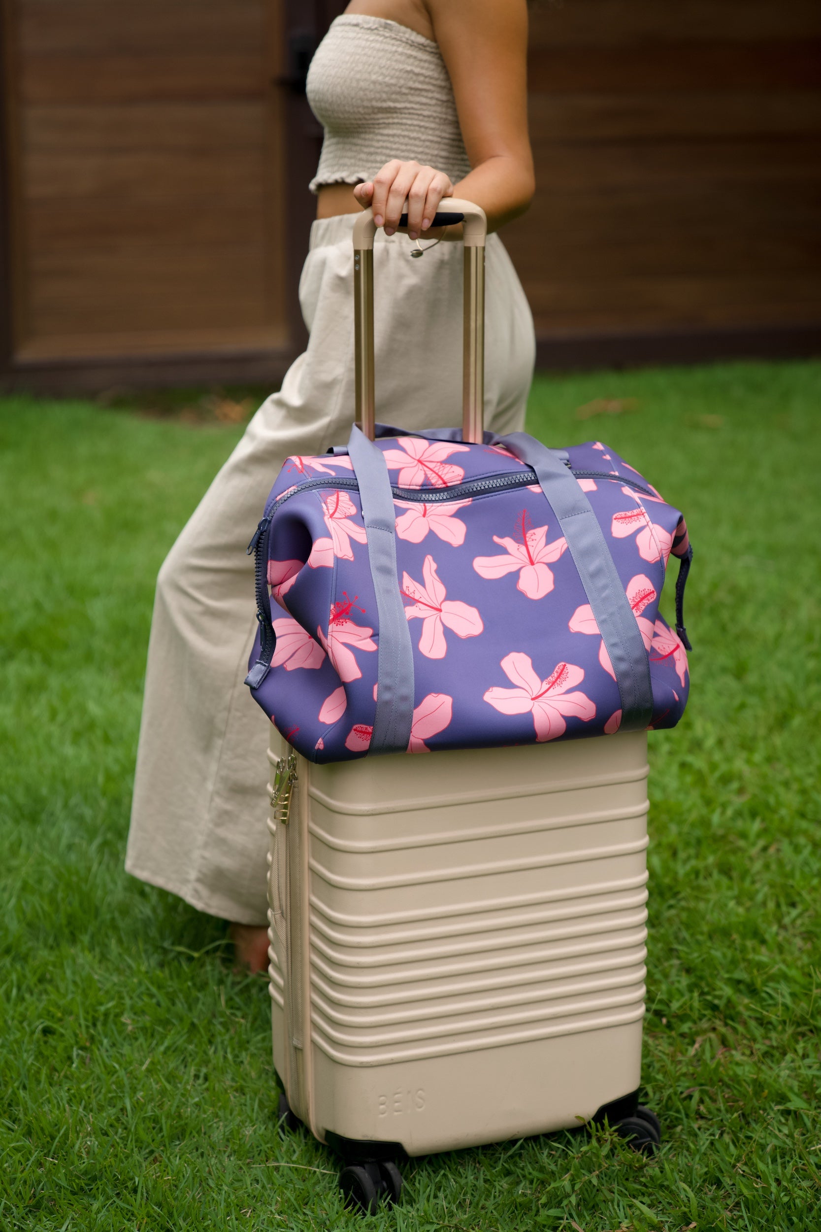 navy blue large travel tote with luggage sleeve, adjustable strap, duster bag, detachable mini pouches, and zipper compartments.