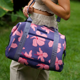 navy blue large travel tote with luggage sleeve, adjustable strap, duster bag, detachable mini pouches, and zipper compartments.