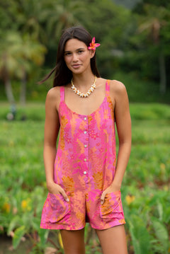 woman wearing a pink tie back romper with lei print
