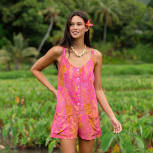 woman wearing a pink tie back romper with lei print