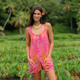 woman wearing a pink tie back romper with lei print