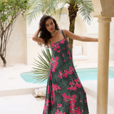 woman with brown hair wearing a dark green thin strap dress with fern and ginger print