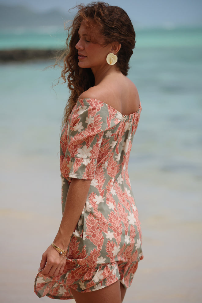 woman with brown hair wearing a  muu style mini dress with ruffle hem with tiare ginger print