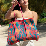 large rich blue neoprene tote bag with red and orange lei pattern