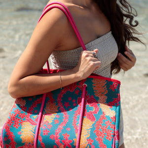 large rich blue neoprene tote bag with red and orange lei pattern