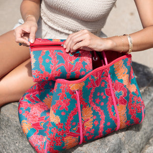 large rich blue neoprene tote bag with red and orange lei pattern