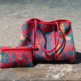 large rich blue neoprene tote bag with red and orange lei pattern