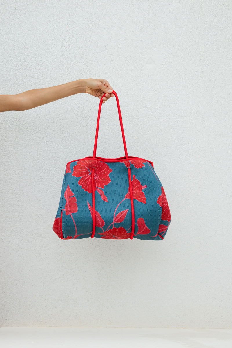 large neoprene tote bag and matching pouch in a bright teal and red mao flower pattern
