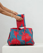 large neoprene tote bag and matching pouch in a bright teal and red mao flower pattern