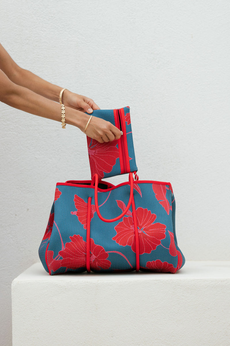 large neoprene tote bag and matching pouch in a bright teal and red mao flower pattern