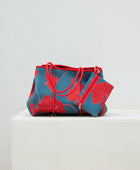 large neoprene tote bag and matching pouch in a bright teal and red mao flower pattern