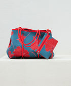 large neoprene tote bag and matching pouch in a bright teal and red mao flower pattern