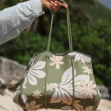 everyday tote bag made from neoprene featuring naupaka and tiare flower on olive green background