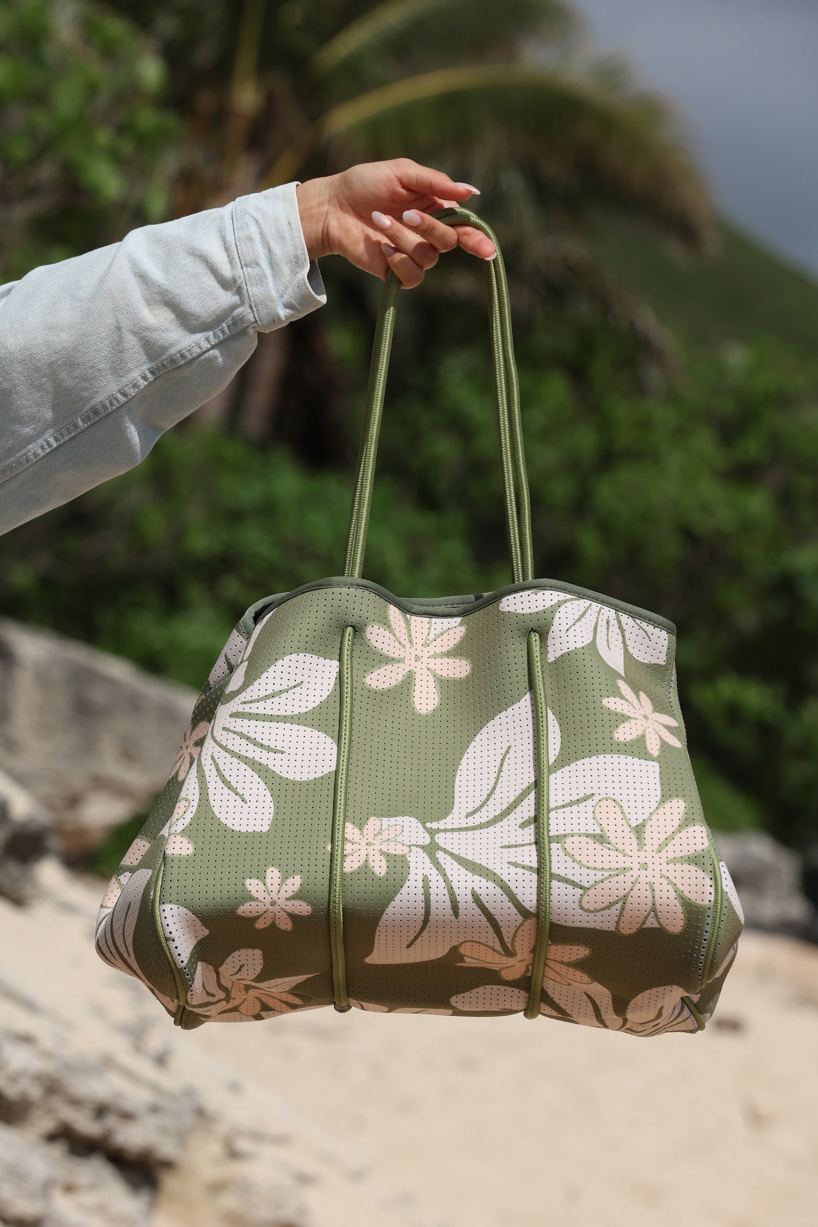 everyday tote bag made from neoprene featuring naupaka and tiare flower on olive green background