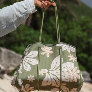 everyday tote bag made from neoprene featuring naupaka and tiare flower on olive green background