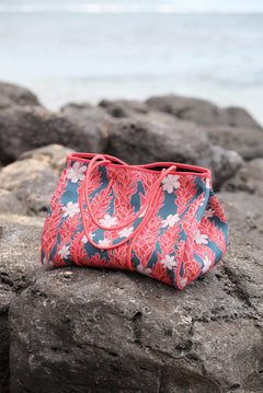 everyday tote bag made from neoprene featuring tiare and ginger flower on a teal background