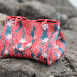 everyday tote bag made from neoprene featuring tiare and ginger flower on a teal background