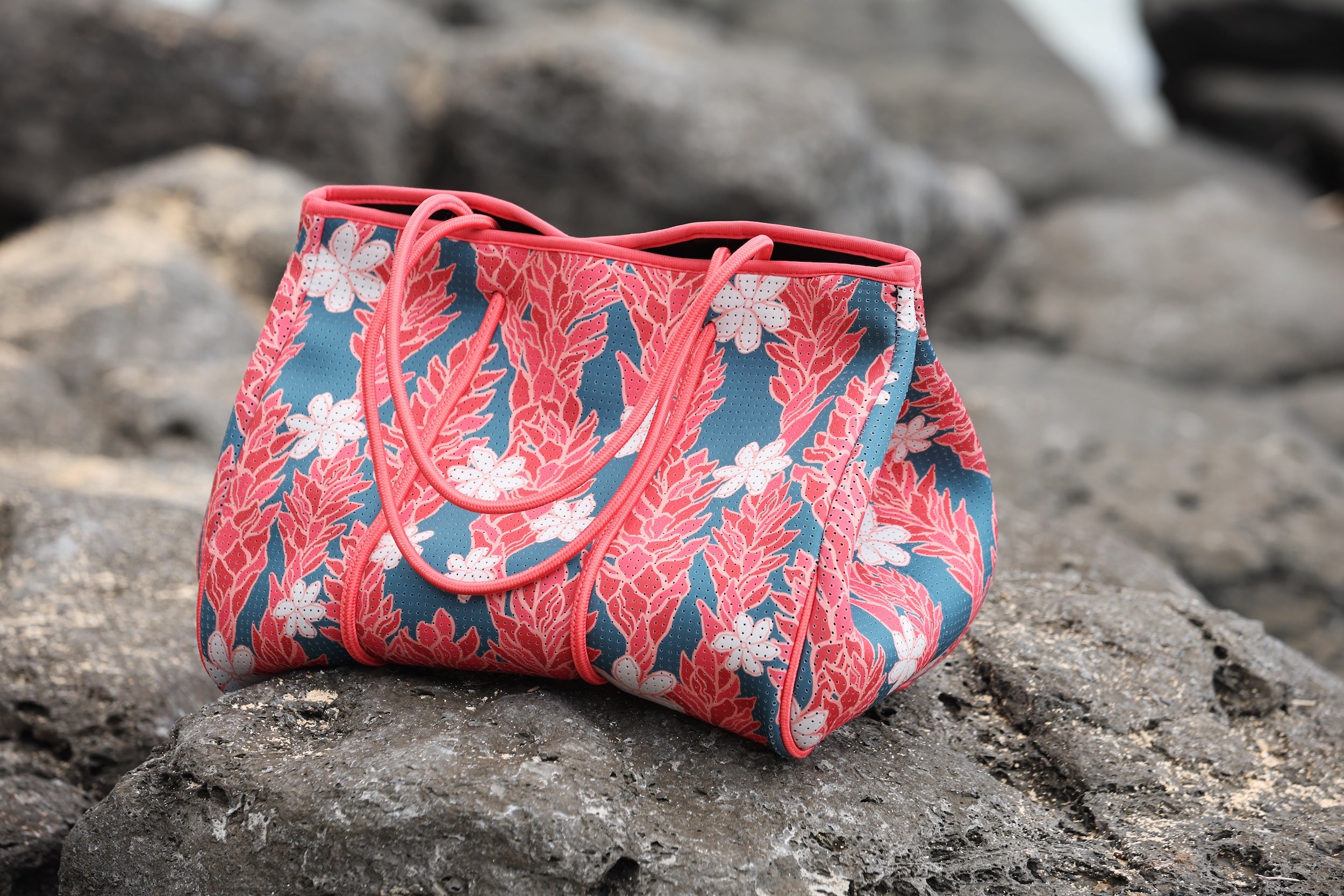 everyday tote bag made from neoprene featuring tiare and ginger flower on a teal background