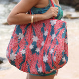 everyday tote bag made from neoprene featuring tiare and ginger flower on a teal background