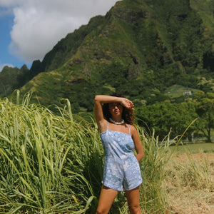 woman with brown hair wearing blue paniolo print overall style romper with bandeau