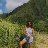 woman with brown hair wearing blue paniolo print overall style romper with bandeau