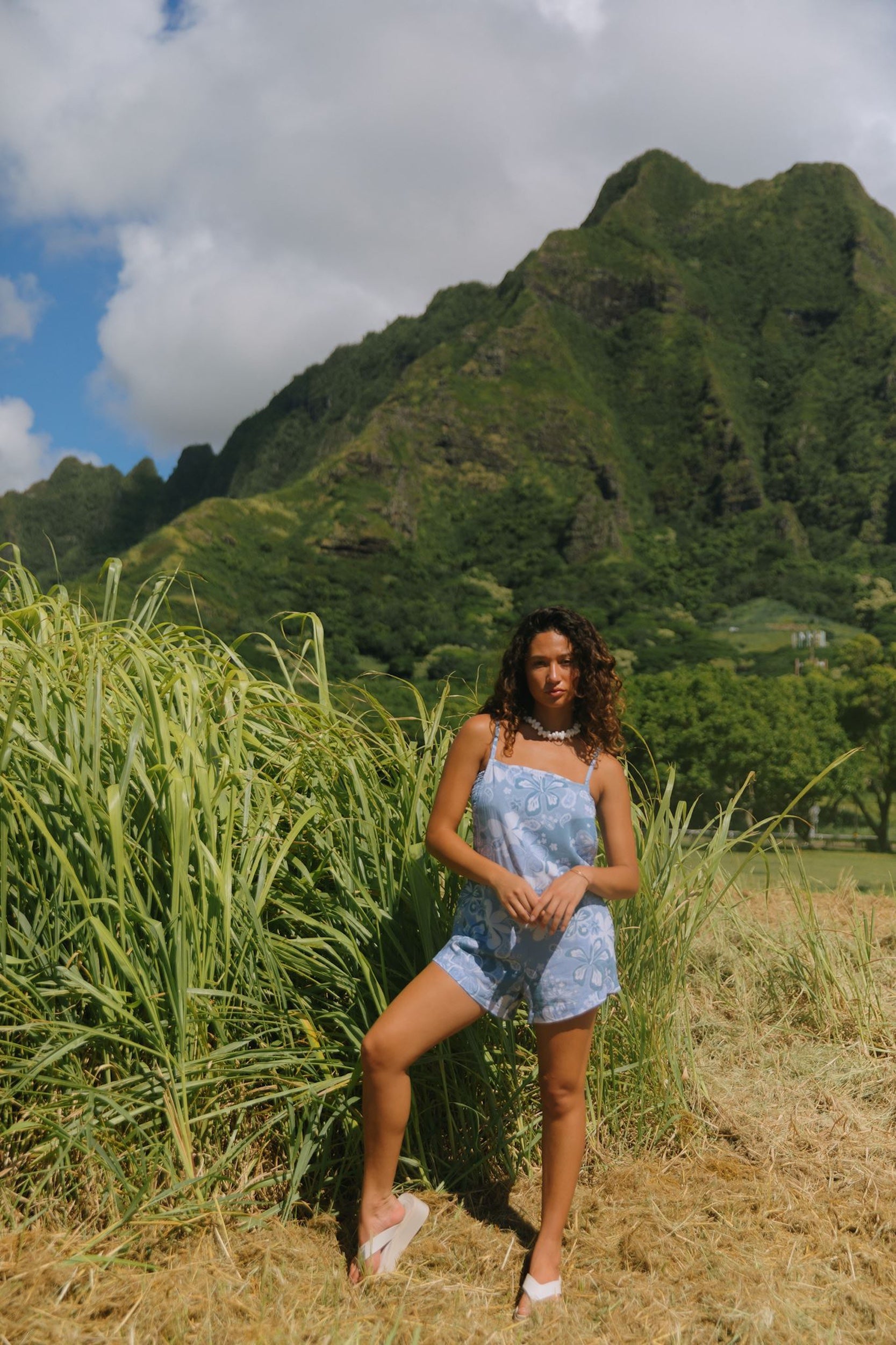 woman with brown hair wearing blue paniolo print overall style romper with bandeau