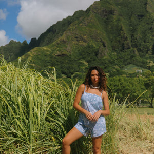 woman with brown hair wearing blue paniolo print overall style romper with bandeau