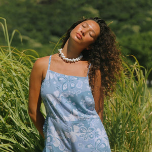 woman with brown hair wearing blue paniolo print overall style romper with bandeau