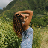 woman with brown hair wearing blue paniolo print overall style romper with bandeau